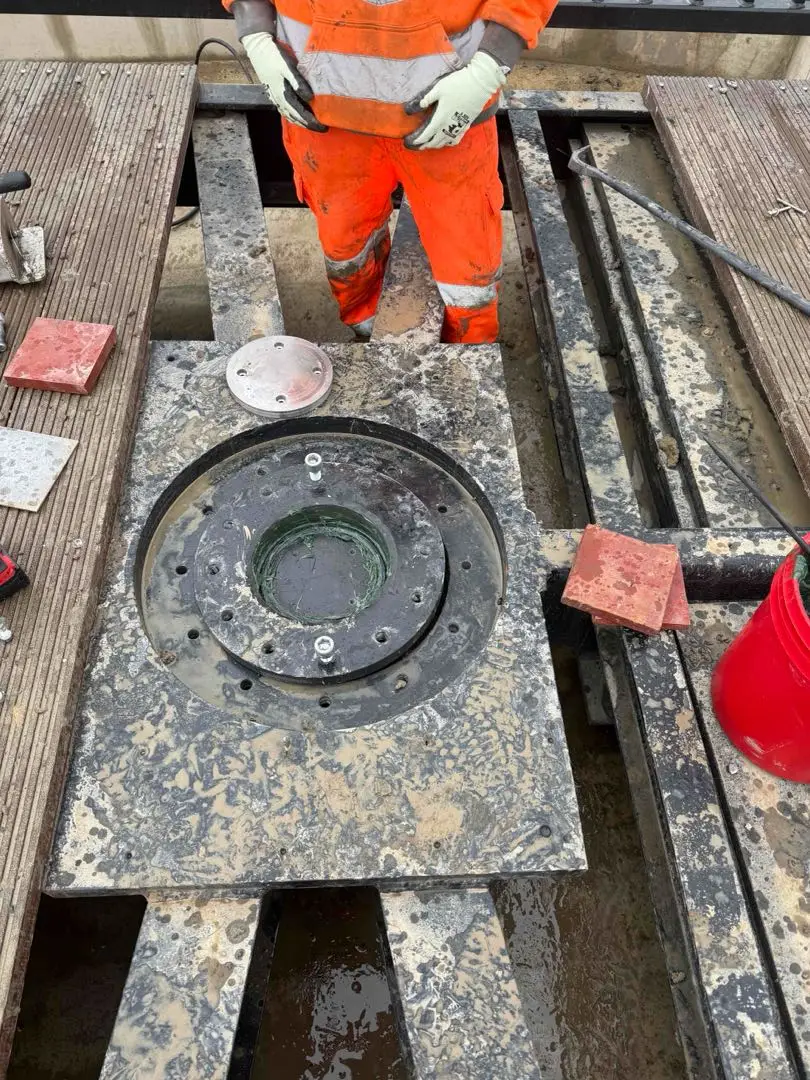 Circular bearing assembly visible through an opening between the bridge deck boards.