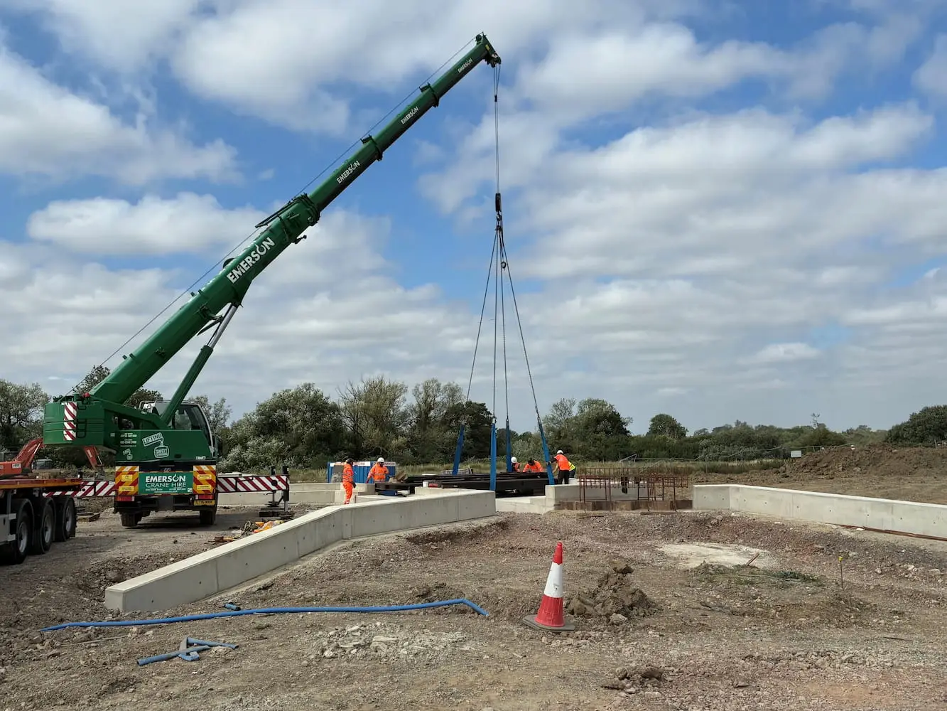 Mobile crane and installation team positioning the bridge at Wichelstowe.